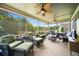Comfortable screened porch features multiple seating areas with ceiling fans for a relaxing outdoor experience at 5585 Lavender Farms Rd, Powder Springs, GA 30127