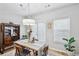Elegant dining room features stylish furniture, modern lighting, and views to a sunny outdoor area at 7710 Bucknell Terrace, Fairburn, GA 30213