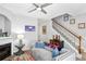 Cozy living room features a fireplace, comfortable seating, and a staircase leading to upper levels at 7710 Bucknell Terrace, Fairburn, GA 30213