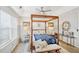 Elegant main bedroom with a four-poster bed and natural light at 7710 Bucknell Terrace, Fairburn, GA 30213