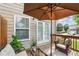 Inviting patio features comfortable seating, a shade umbrella, and access through double doors at 7710 Bucknell Terrace, Fairburn, GA 30213