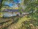 View of the backyard and rear of the home, siding, small patio area, and trees at 1596 Allgood Rd, Stone Mountain, GA 30083