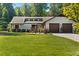 Charming single-story home with well-manicured lawn and two-car garage offers great curb appeal at 195 Pine Trail Rd, Fayetteville, GA 30214
