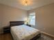 Inviting bedroom showcasing a comfortable bed, neutral walls and a large window at 2481 Southhaven Ln, Buford, GA 30519