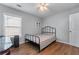 Cozy bedroom features hardwood floors, neutral walls and black metal bed frame at 2481 Southhaven Ln, Buford, GA 30519