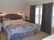Bedroom with neutral colors, large bed, and windows with gray curtains at 2481 Southhaven Ln, Buford, GA 30519