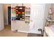 Bright bedroom area with unique wall storage, a white door, and a neutral color scheme at 2481 Southhaven Ln, Buford, GA 30519