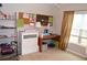 Bright bedroom space with a window and stylish golden curtains, complemented by a desk and cabinet storage at 2481 Southhaven Ln, Buford, GA 30519