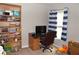 Cozy bedroom featuring a bookshelf, desk, and a window with stylish blue striped curtains at 2481 Southhaven Ln, Buford, GA 30519
