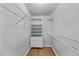 Walk-in closet with shelving units and hardwood floors at 2481 Southhaven Ln, Buford, GA 30519