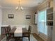 Elegant dining room featuring a chandelier, hardwood floors, and natural light at 2481 Southhaven Ln, Buford, GA 30519