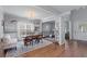 Bright dining area with hardwood floors, a large window, and an open layout to the living room at 2481 Southhaven Ln, Buford, GA 30519