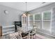 Cozy dining area with hardwood flooring and natural light from a large window at 2481 Southhaven Ln, Buford, GA 30519