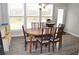 Cozy dining room with a wooden table, six chairs, and large bright windows offering natural light at 2481 Southhaven Ln, Buford, GA 30519