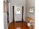 Warm entryway with hardwood floors, a console table, and a view of the glass-paneled front door at 2481 Southhaven Ln, Buford, GA 30519
