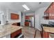 Well-lit kitchen featuring stainless steel appliances, granite countertops, and wood-look flooring at 2481 Southhaven Ln, Buford, GA 30519