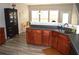 Well-lit kitchen area with stainless steel sink, gray countertops, and brown cabinets at 2481 Southhaven Ln, Buford, GA 30519