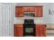 A functional kitchen featuring light granite countertops, dark cabinets, and essential modern appliances at 2481 Southhaven Ln, Buford, GA 30519