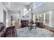 Bright living room featuring hardwood floors, plentiful windows, and comfortable leather sofas at 2481 Southhaven Ln, Buford, GA 30519