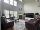 Comfortable living room featuring a fireplace, high ceilings, and natural light at 2481 Southhaven Ln, Buford, GA 30519