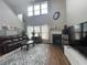 Bright living room with a fireplace, hardwood floors, large windows, and a comfortable sofa at 2481 Southhaven Ln, Buford, GA 30519