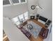Aerial view of bright living room with fireplace, hardwood floors, and comfortable leather sofas at 2481 Southhaven Ln, Buford, GA 30519