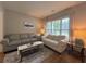 Cozy living room featuring neutral tones, comfortable seating, and a bright window at 2481 Southhaven Ln, Buford, GA 30519