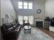 Spacious living room with high ceilings, a fireplace, and comfortable seating at 2481 Southhaven Ln, Buford, GA 30519