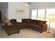 Spacious living room with a large sectional sofa, bright windows, and a decorative wall hanging at 2481 Southhaven Ln, Buford, GA 30519