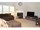 Living room with a large sectional sofa, fireplace, a TV, and bright windows for natural light at 2481 Southhaven Ln, Buford, GA 30519