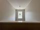 Bright loft area featuring a modern light fixture and large window at 2481 Southhaven Ln, Buford, GA 30519