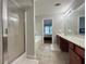 Bathroom with a glass-enclosed shower, soaking tub, double vanity, and tile flooring at 2481 Southhaven Ln, Buford, GA 30519