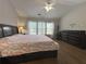 Bright main bedroom boasting an inviting bed, dressers, and a well-lit atmosphere at 2481 Southhaven Ln, Buford, GA 30519