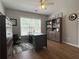 Well-lit home office with a large desk and built-in shelving at 2481 Southhaven Ln, Buford, GA 30519