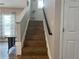 Stairway featuring hardwood steps and a modern black railing at 2481 Southhaven Ln, Buford, GA 30519