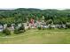 A picturesque neighborhood featuring well-manicured lawns, surrounded by lush greenery and a serene lake at 5345 Glenhaven Dr, Cumming, GA 30041