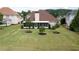 Spacious backyard features a well-manicured lawn, small trees, and a screened in porch at 5345 Glenhaven Dr, Cumming, GA 30041
