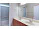 Bright bathroom featuring a double sink vanity with wood cabinets, a large mirror, and a tub/shower combo at 5345 Glenhaven Dr, Cumming, GA 30041