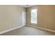 Neutral bedroom with carpet, white trim, and a window offering natural light at 5345 Glenhaven Dr, Cumming, GA 30041