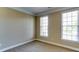 Neutral bedroom with carpeted floors, and bright windows that offer a view of the neighborhood outside at 5345 Glenhaven Dr, Cumming, GA 30041