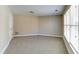 Bright bedroom with neutral carpet, tan walls, and large windows allowing lots of natural light at 5345 Glenhaven Dr, Cumming, GA 30041