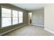 Bright bedroom featuring neutral carpet, tan walls, and double windows providing plenty of natural light at 5345 Glenhaven Dr, Cumming, GA 30041