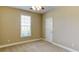 Neutral bedroom with carpeted floors, a bright window, a white door, and neutral colored walls at 5345 Glenhaven Dr, Cumming, GA 30041