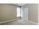 Cozy bedroom with carpet flooring, a window with blinds, and a white door at 5345 Glenhaven Dr, Cumming, GA 30041