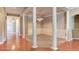 Elegant dining room featuring hardwood floors, decorative columns, wainscoting, and chandelier lighting at 5345 Glenhaven Dr, Cumming, GA 30041