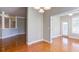 Dining area with hardwood floors, decorative columns, an adjacent dining area, and a back door for natural light at 5345 Glenhaven Dr, Cumming, GA 30041
