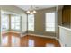 Bright dining room with hardwood floors and large windows offering views of the lush, green backyard at 5345 Glenhaven Dr, Cumming, GA 30041