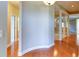 Inviting hallway featuring elegant wood floors, neutral walls and decorative pillars with a view to adjacent rooms at 5345 Glenhaven Dr, Cumming, GA 30041