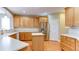 Bright kitchen features a center island, light wood cabinetry, stainless steel appliances, and a tile backsplash at 5345 Glenhaven Dr, Cumming, GA 30041