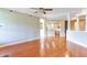 Open-concept living room with hardwood floors, crown molding, decorative columns, and access to the kitchen at 5345 Glenhaven Dr, Cumming, GA 30041